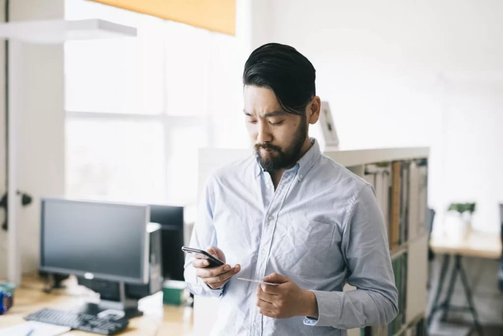 man holding phone and credit card.width .jpg