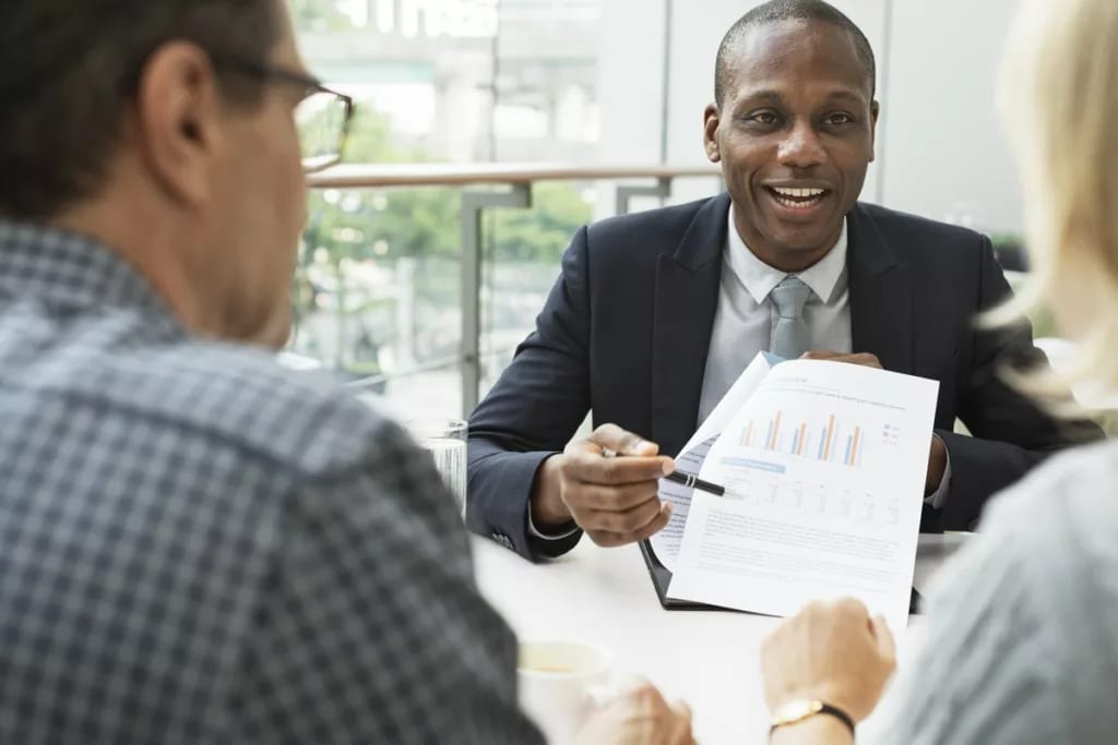 mature couple talking to financial advisor PO.width CEYgc.jpg
