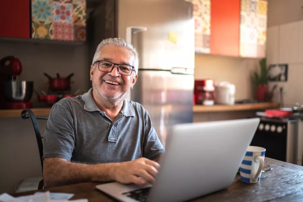 older man laptop smiling gettyimages .jpg