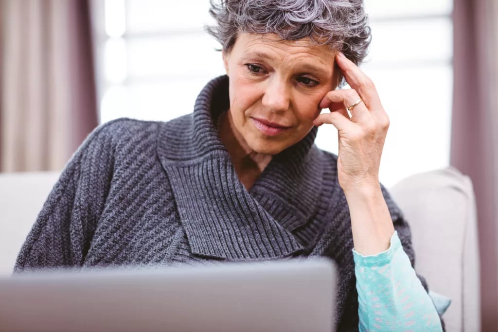 person with a worried expression looking at a laptop copy.jpg
