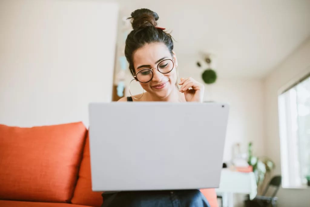 smiling person looking at laptop.jpg