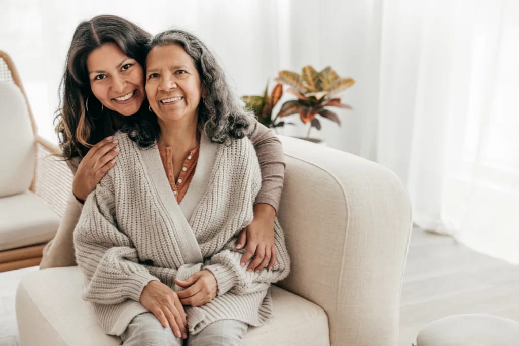 two people sitting on a couch and smiling.jpg