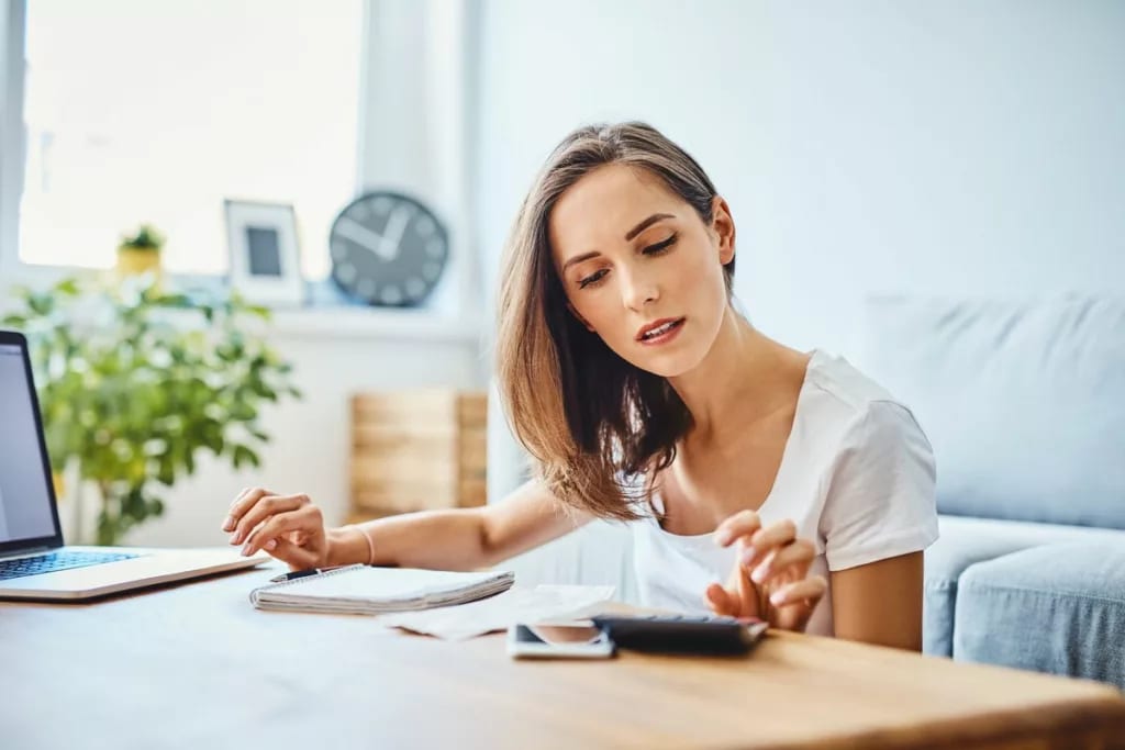 woman with calculator at home.width .jpg