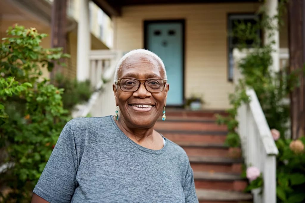 getty smiling happy by porch house.jpg