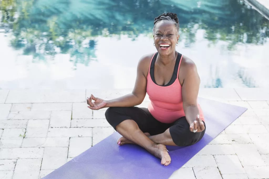 getty smiling happy meditating yoga.jpg
