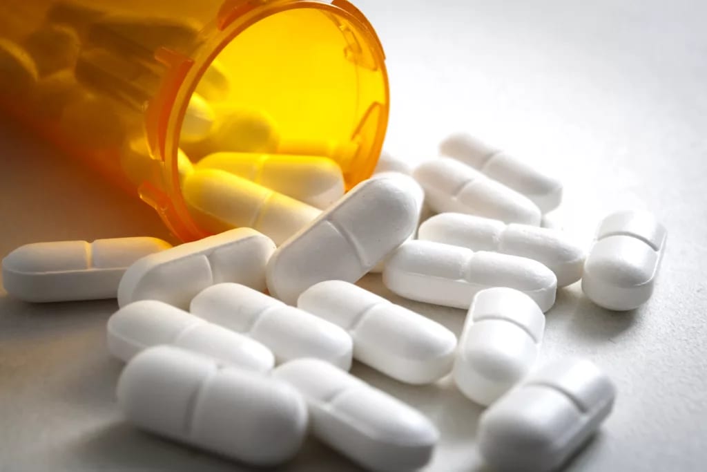 open pill bottle spilling out.jpg