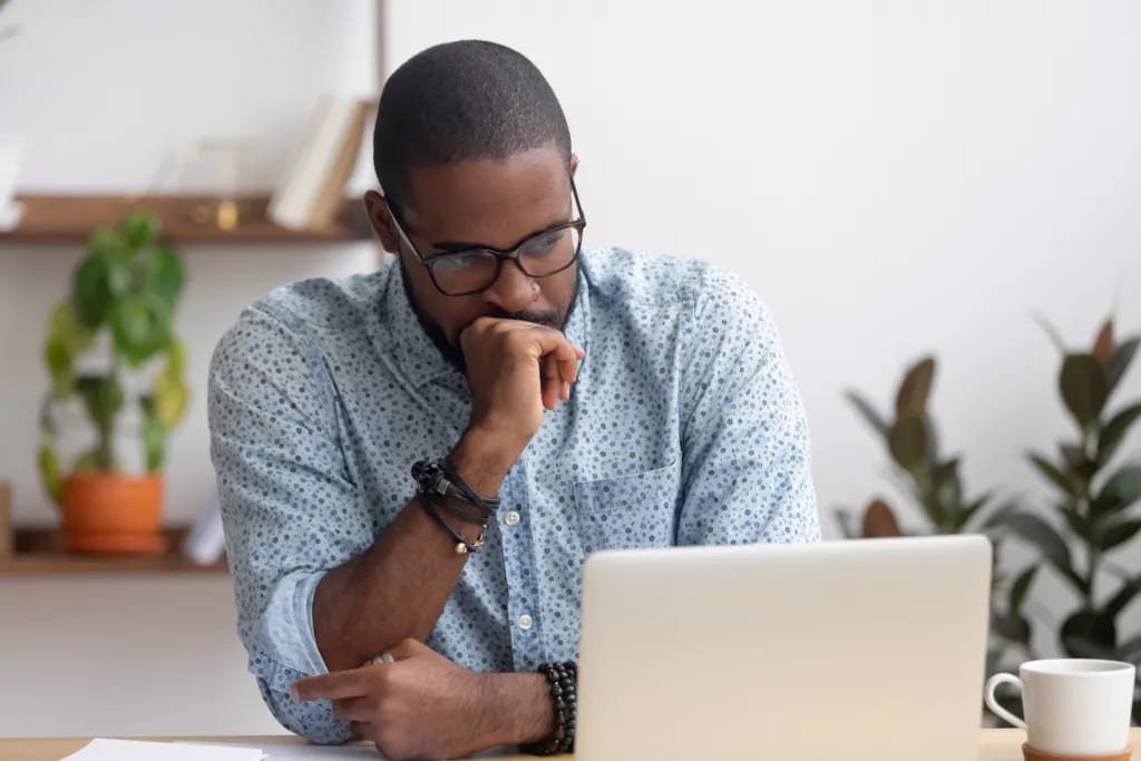 person feeling worried looking at a laptop.jpg