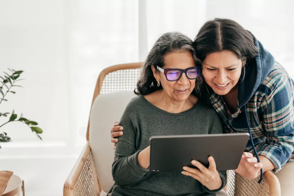 two people looking at a tablet and smiling.jpg