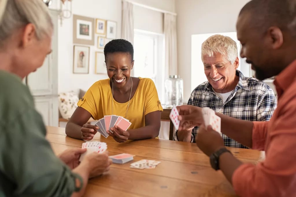 getty friends playing cards card games.jpg