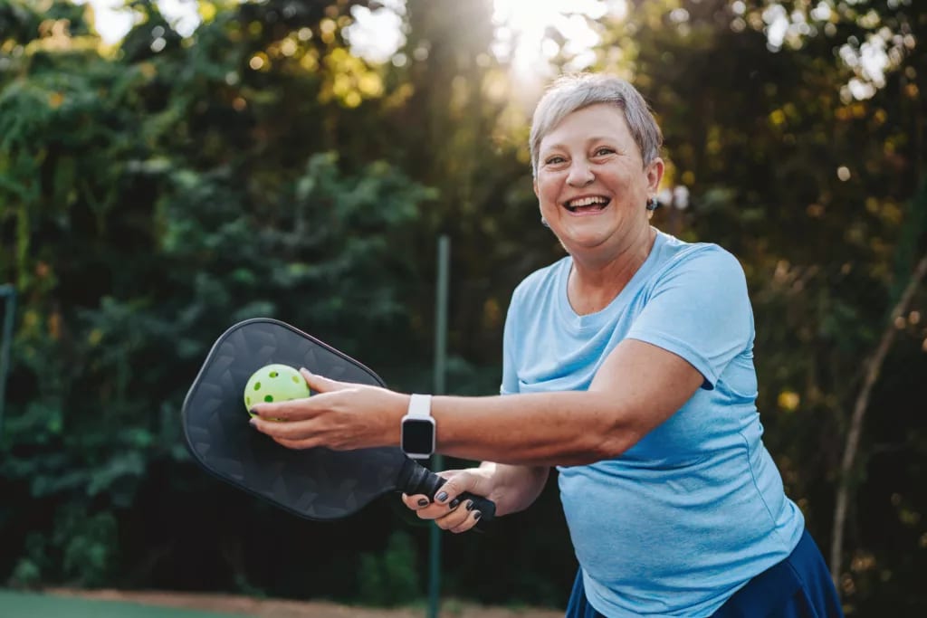 getty happy smiling pickleball player exercise fitness sports.jpg