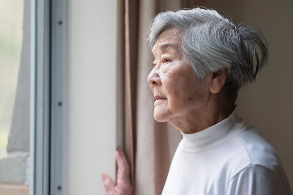 getty looking out window concerned worried older thoughtful.jpg