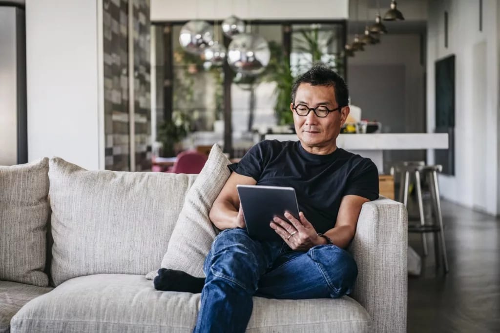 man on couch with tablet FFkBeEk.width .jpg