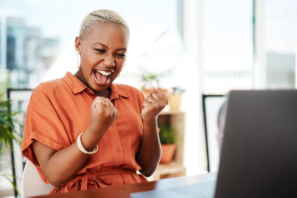 person celebrating victory while looking at computer.jpg