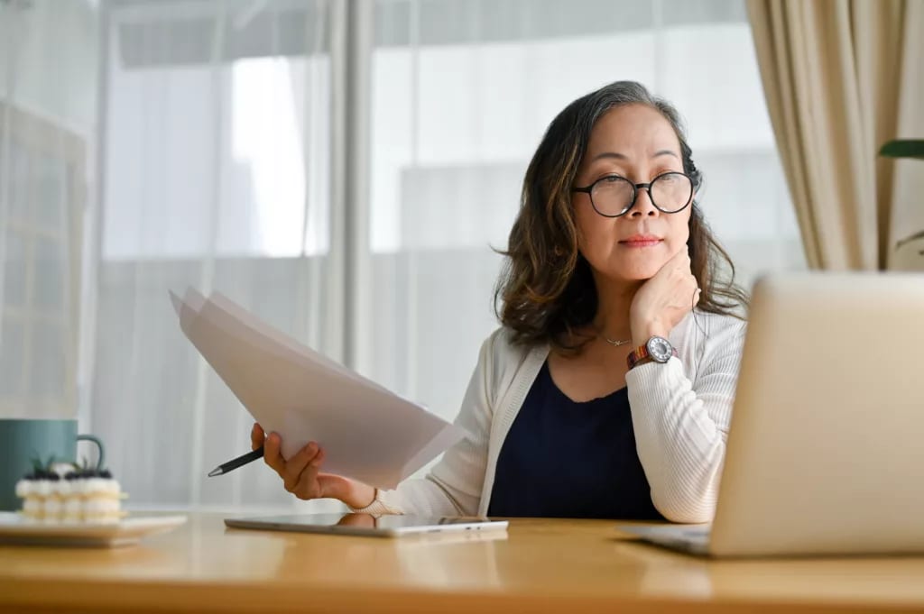 senior businesswoman laptop office work getty.jpg