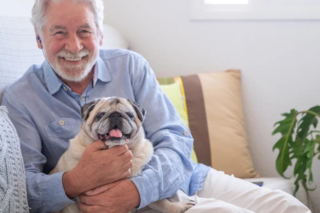 smiling person holding dog gettyimages .jpg