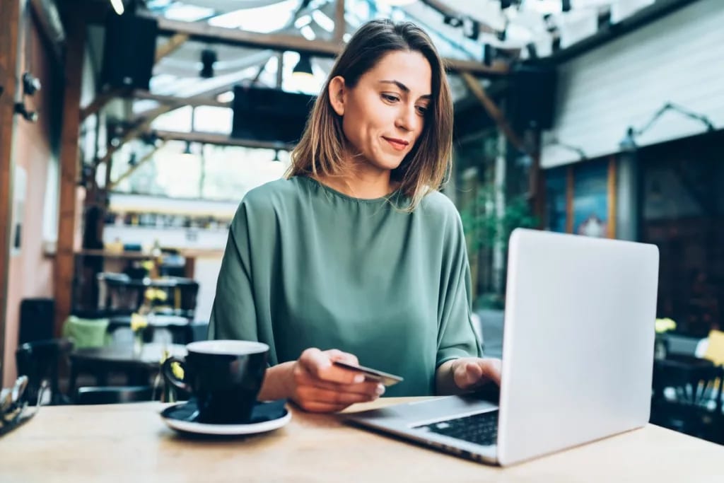 woman in cafe with laptop and credit card.width .jpg