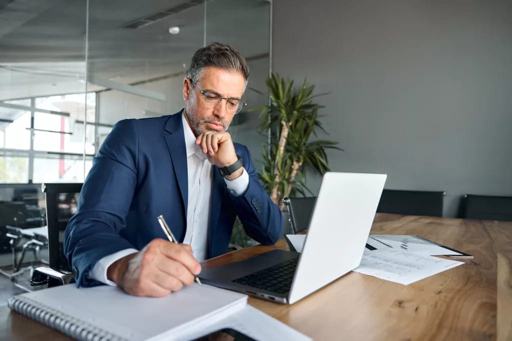 man s biz suit desk taking notes gettyimages .jpg