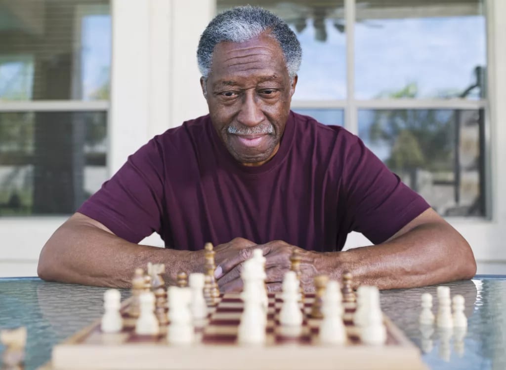 older man playing chess strategy moves winning.jpg