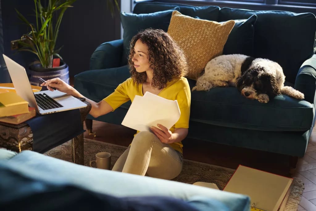 person sitting on the floor looking at a laptop.jpg