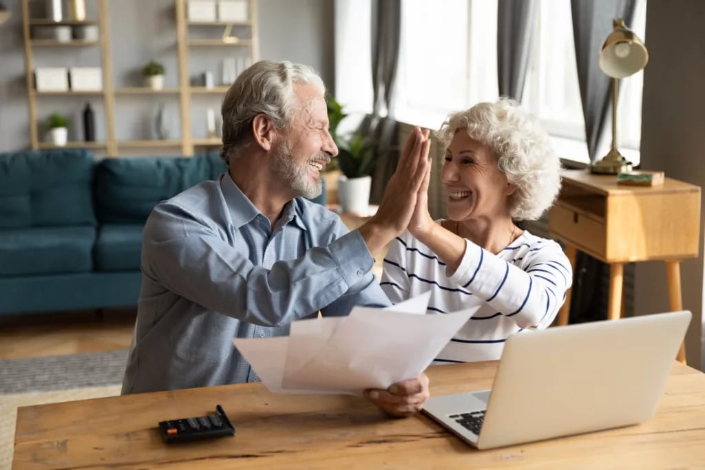 retired couple reviewing finances on a laptop.jpg