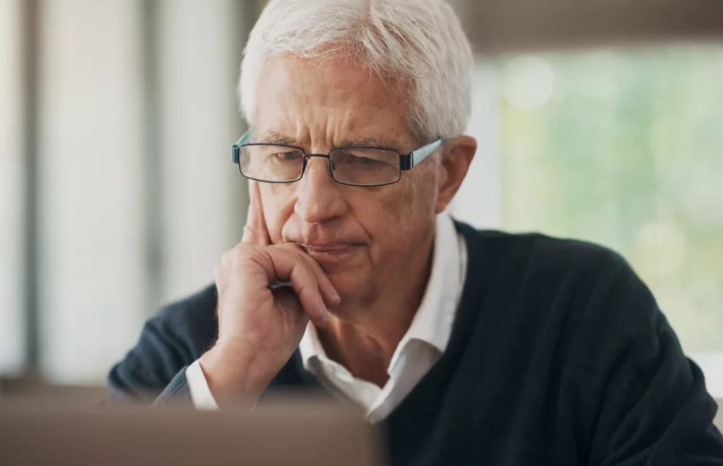 serious man staring intently at laptop.jpg