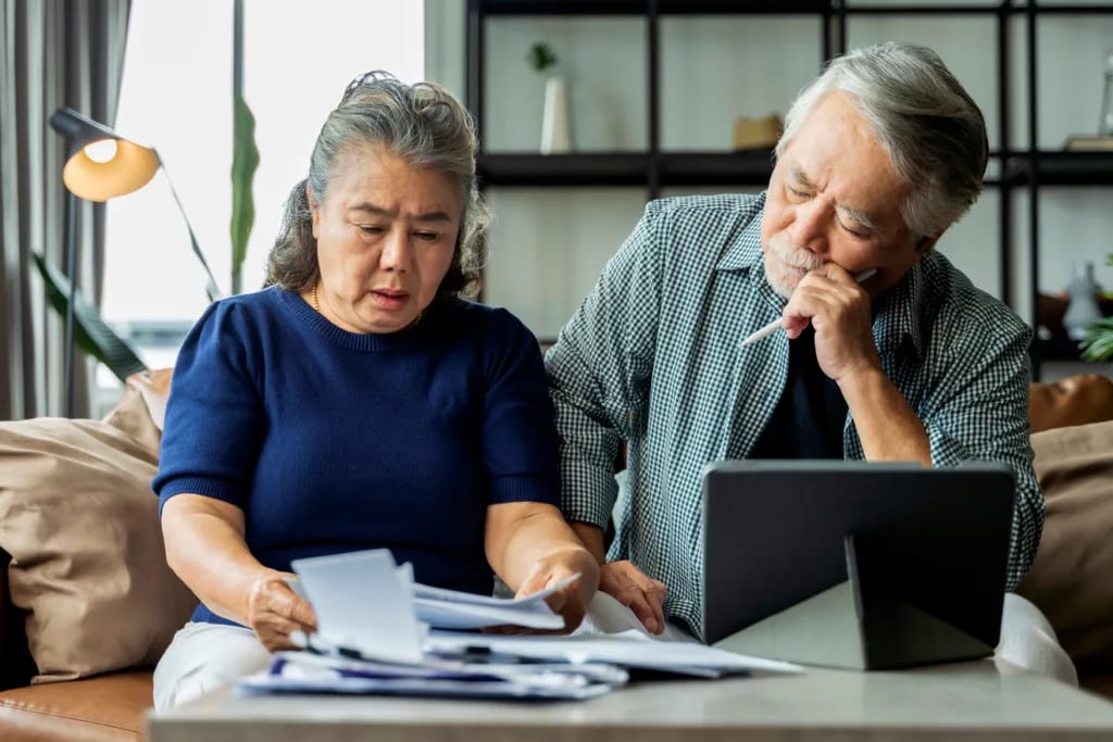 stressed couple looking at documents together.jpg