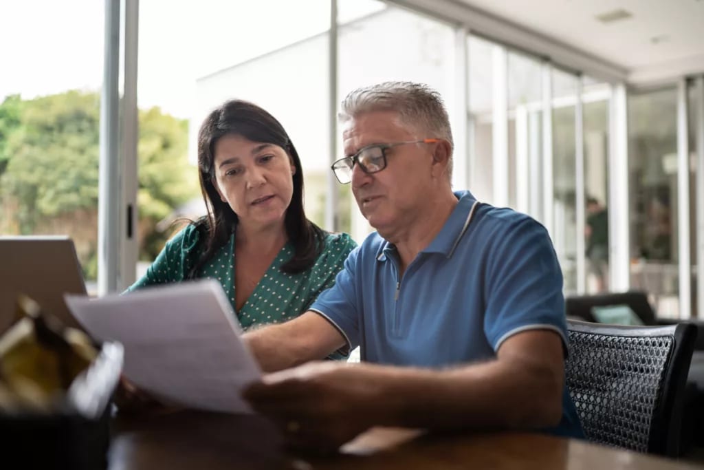middle aged couple looking at document.jpg