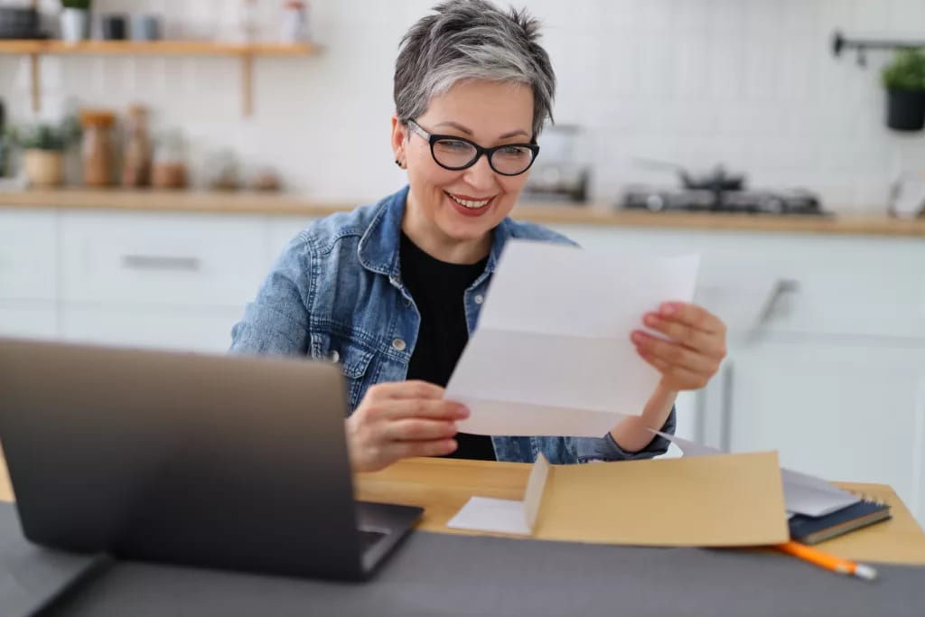 older woman document laptop gettyimages .jpg