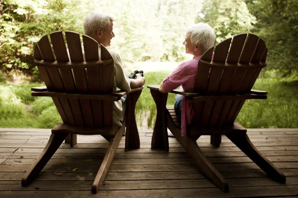 senior couple sitting in chairs on porch.jpg