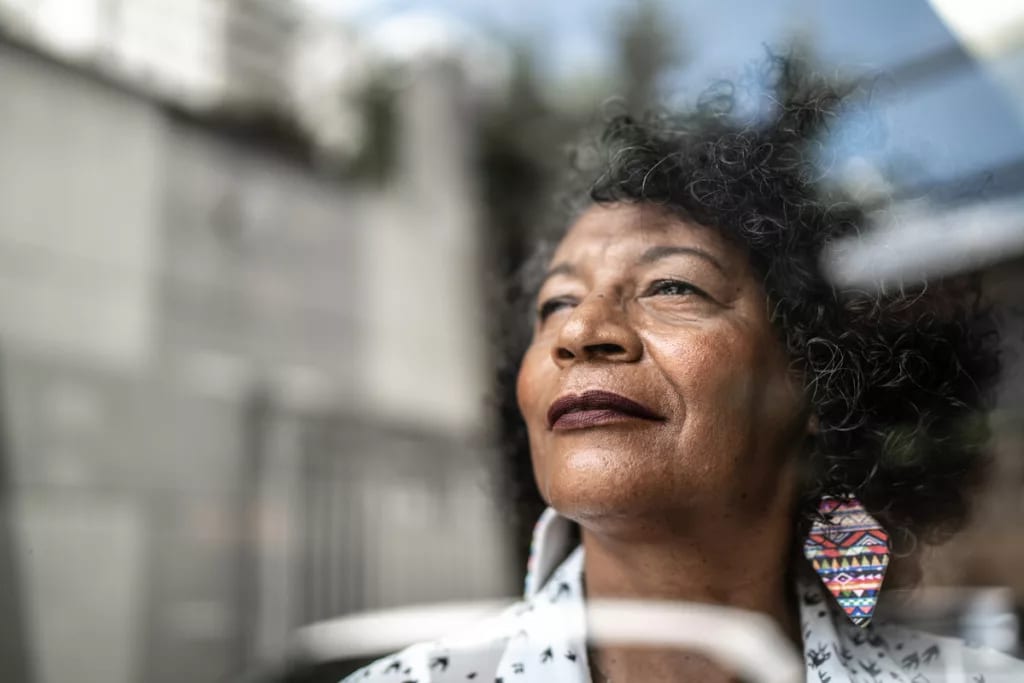 smiling person looking out window.jpg