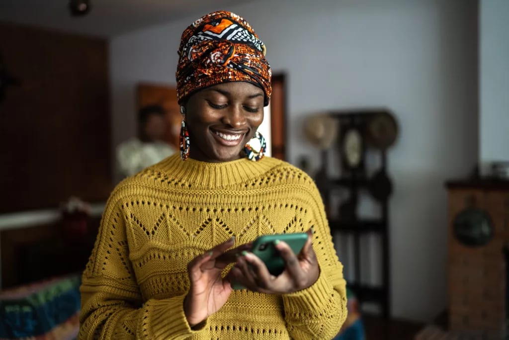 smiling person looking at smartphone.jpg