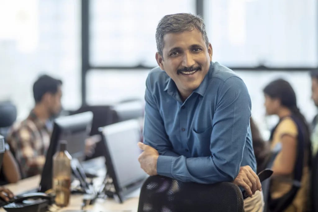 getty happy smiling business person at office.jpg