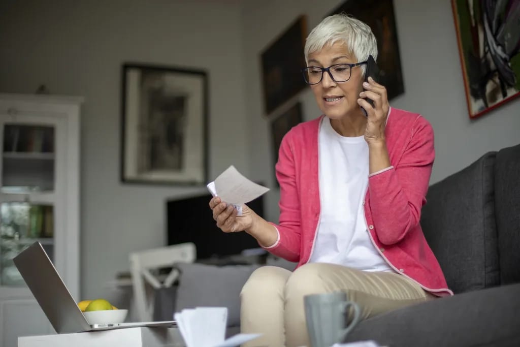 senior holding check and talking on phone.jpg