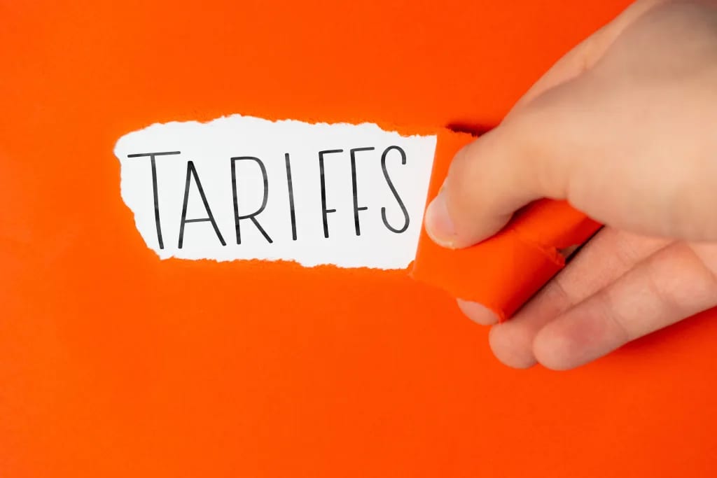 tariffs on torn orange paper.jpg