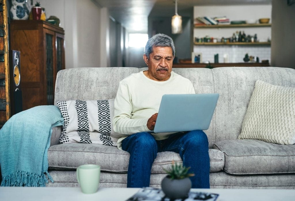 senior man laptop couch gettyimages .jpg