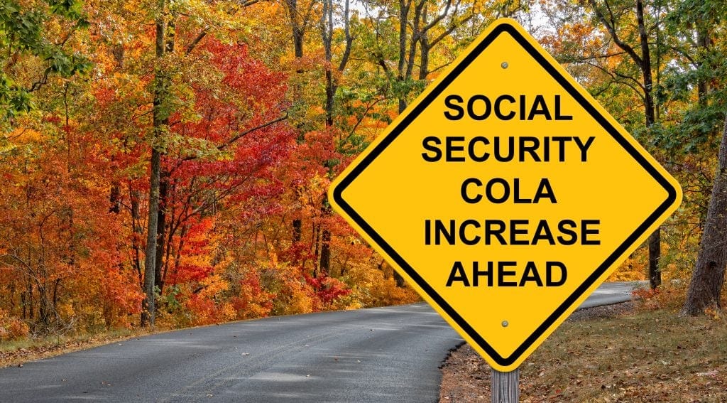 A yellow sign that says Social Security COLA increase ahead.