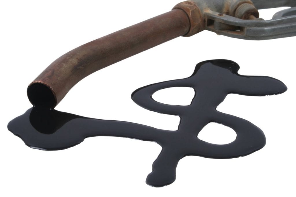 Oil making a dollar sign as it leaks out of a pipe.