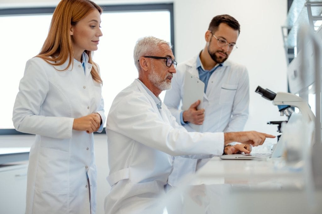 Three researchers working in a lab.
