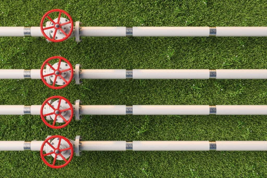 Four pipes with red handles on them.