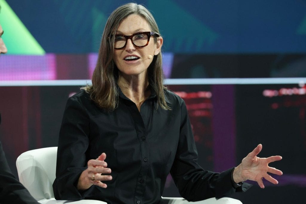 Ark Investment Management founder Cathie Wood speaking on stage at a conference.