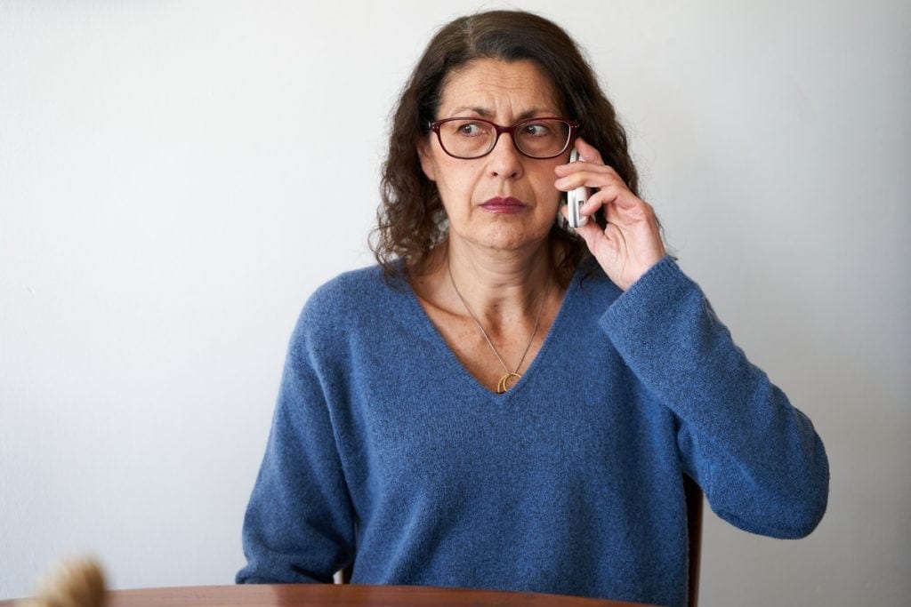 Confused person talking on phone.