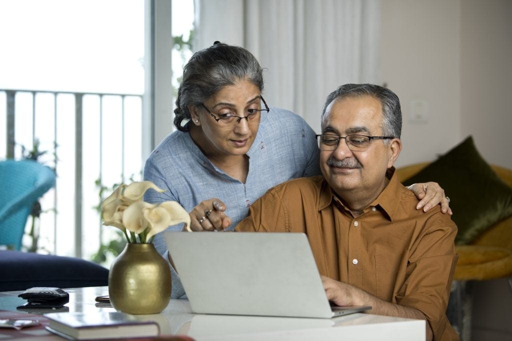 Two people at a laptop.
