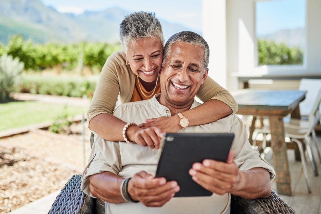 Two people looking at a tablet.