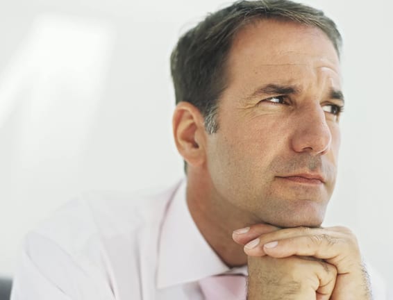 getty images mature man thinking with chin resting on hands planning retirement.jpeg