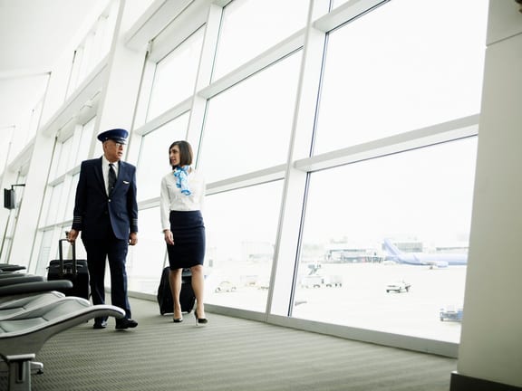 Pilot and flight attendant walking to airport.width LhaGV.jpg