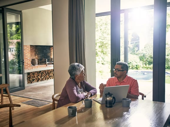 two people at a table with a laptop open gettyimages .jpg
