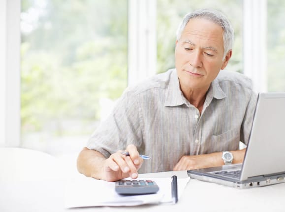 senior man using calculator gettyimages .jpg