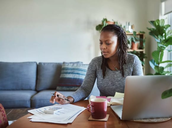 Woman making calculations as she uses her lap.width xufh.jpg