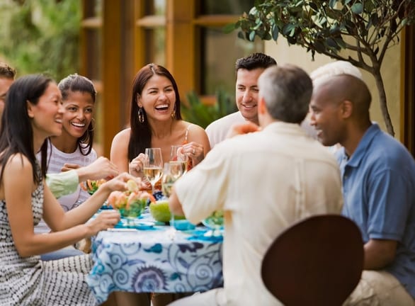 Group of friends dining on restaurant patio t.width