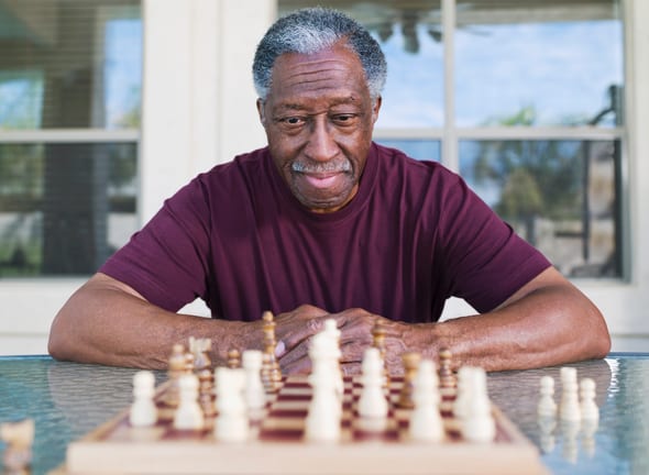 getty older man playing chess strategy moves winning.jpg